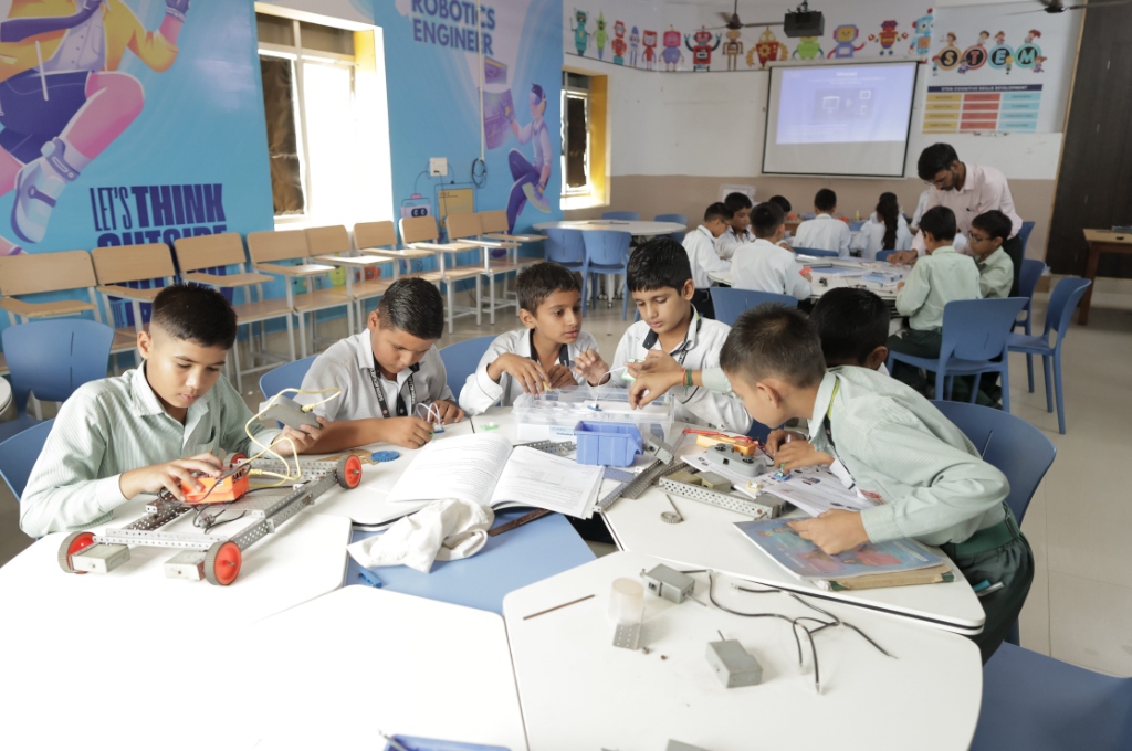 Students assembling robotics in an Edubull school lab